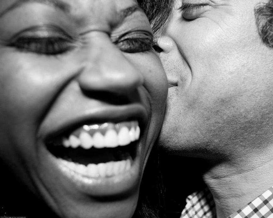Black and white photo of a couple kissing