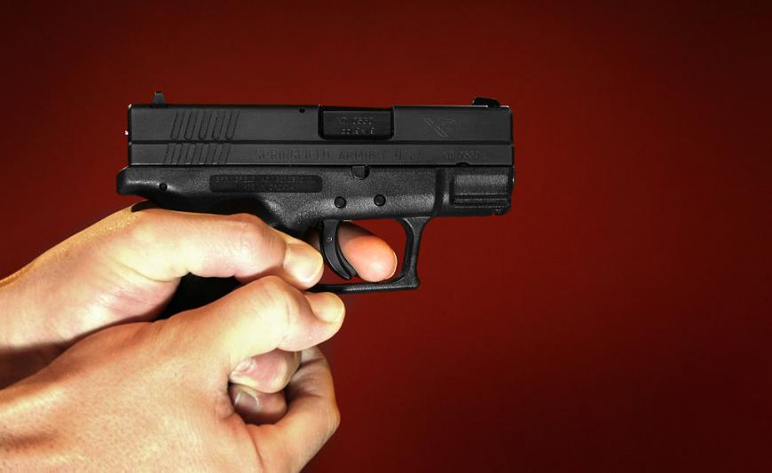 Black Springfield XD 9mm Luger handgun with red background