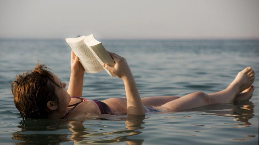 Woman reading a book like floating in the dead sea
