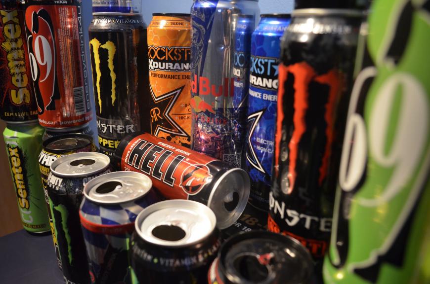 Cans of energy drinks stacked on top of each other. Red Bull, Rock Star, etc. 