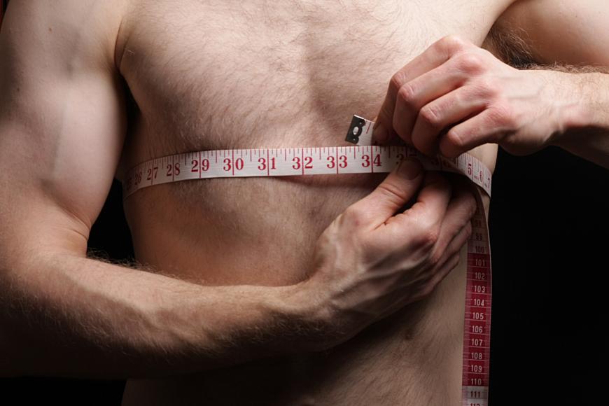 Man measuring his body