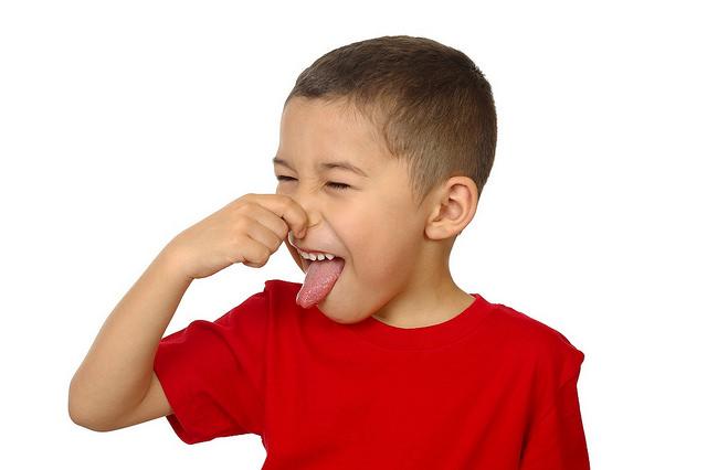 Child pinching his nose at a bad smell