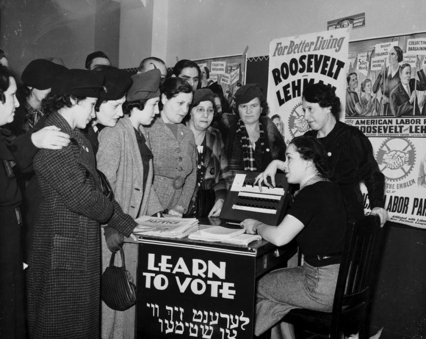 Women surrounded by political posters, learning how to vote in 1935