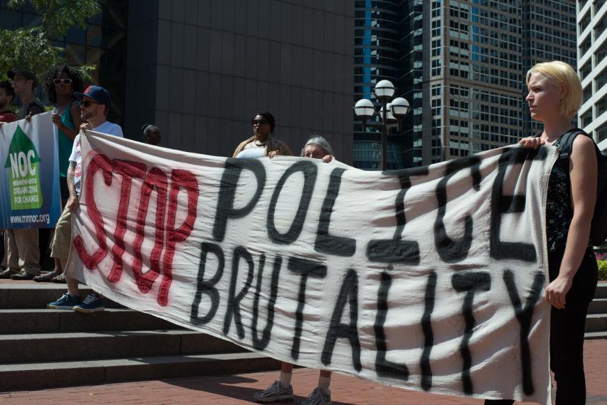 Young people carrying hand-painted signs in a rally against police brutality.