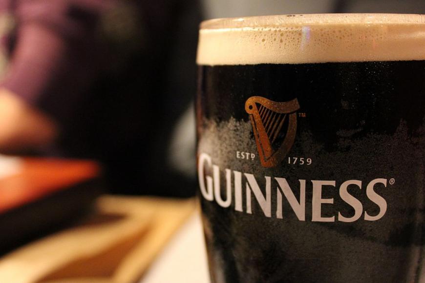 a pint of foamy Guinness beer