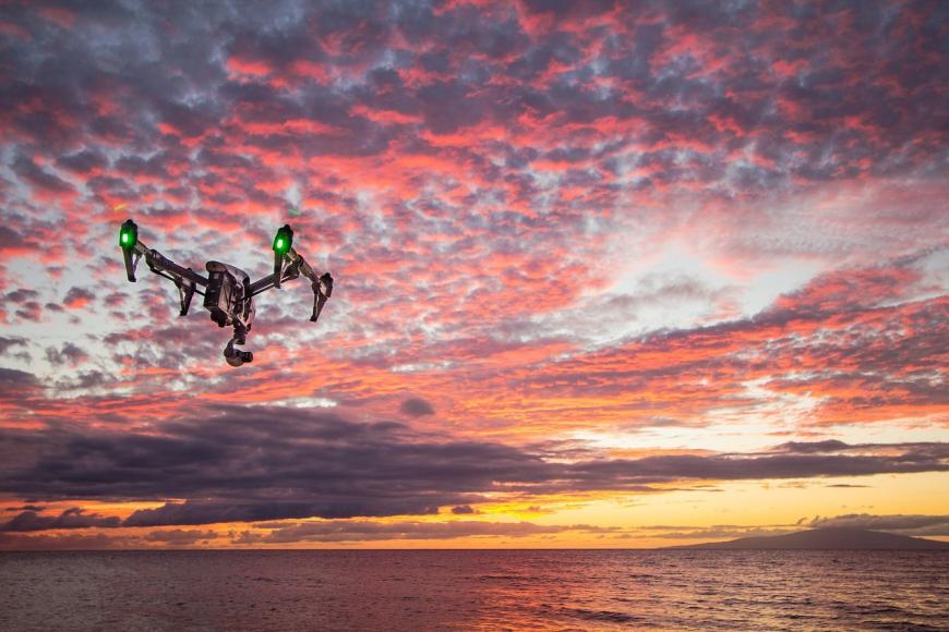 Drone flying into sunset