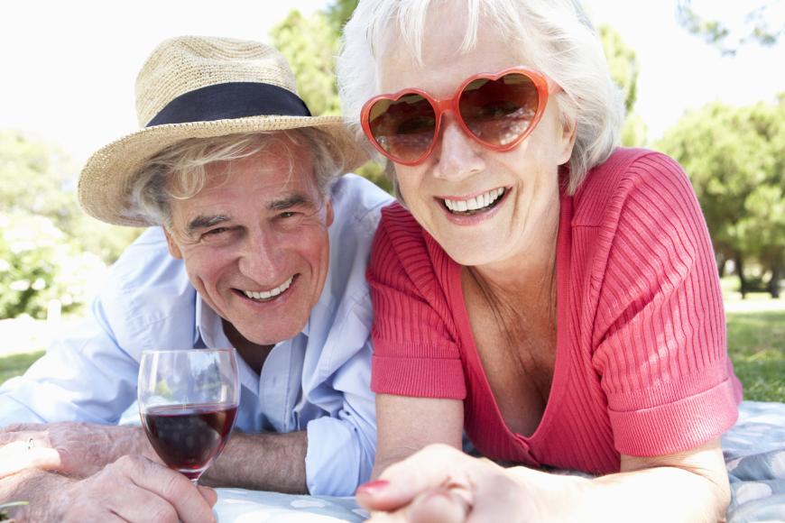 Elderly grandparents enjoying life at a picnic.