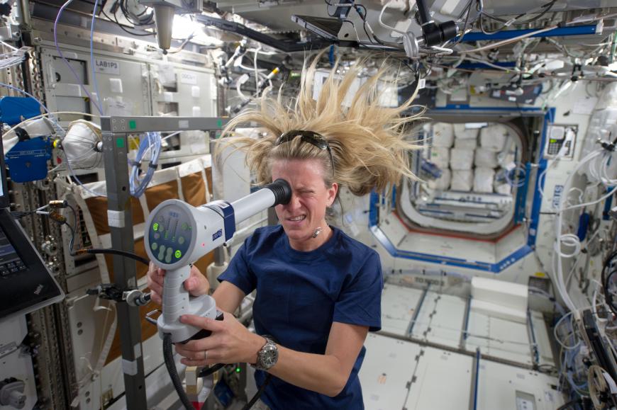Astronauts Karen Nyberg uses a fundoscope aboard the International Space Station
