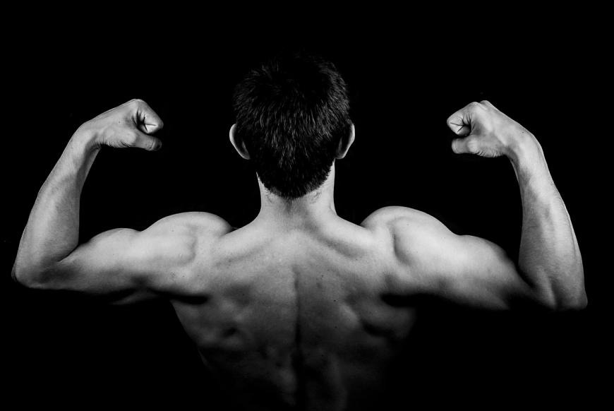 Man flexing shoulder muscles, biceps