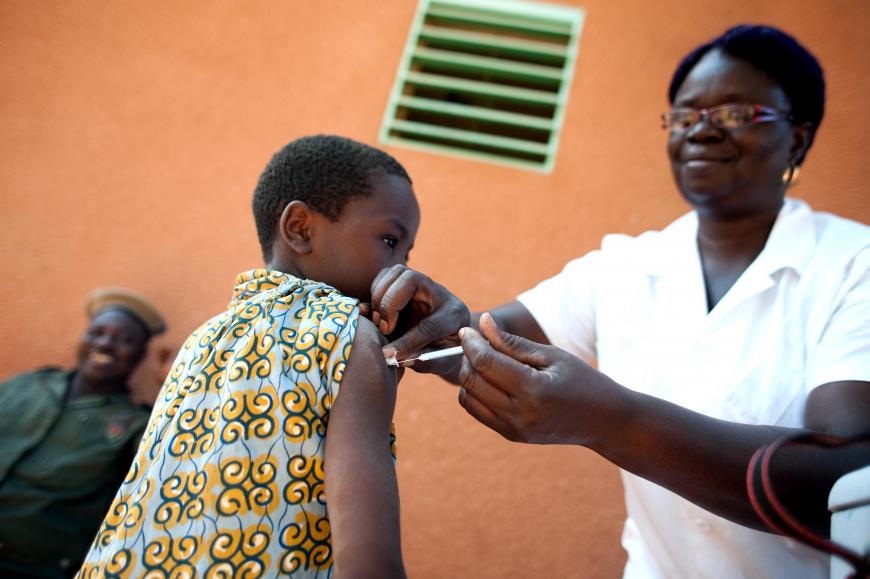 A child receives an injection to his shoulder