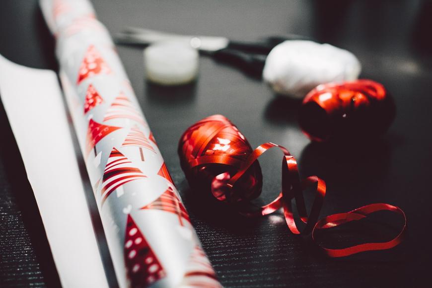 A roll of Christmas wrapping paper and ribbons