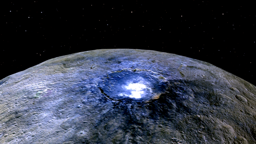 Bright spot in a crater on the surface of Ceres, a dwarf planet. surrounding area is glowing indigo.