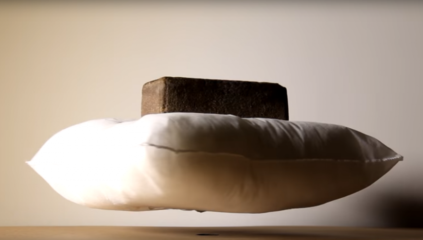 Pillow levitating with brick on top