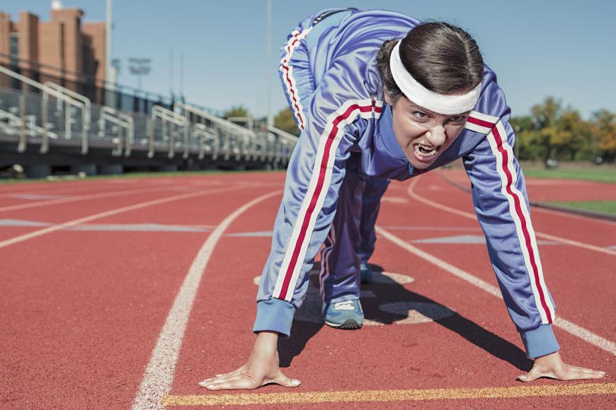 Runner prepares to sprint on track
