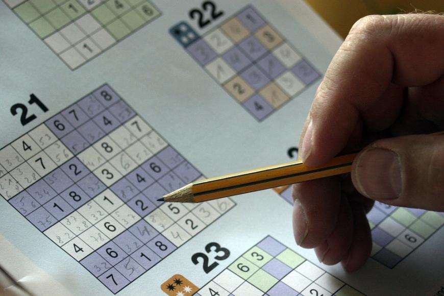 Close-up of a pencil and sudoku puzzle