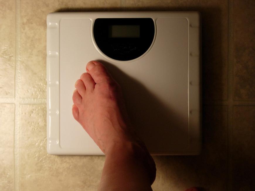 Foot on a scale. Weight.