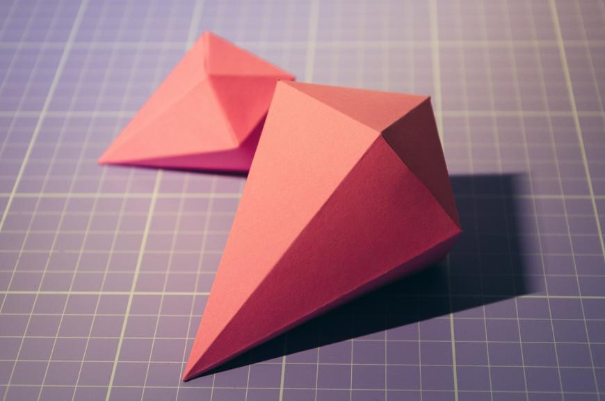 Origami, diamond shaped, on grid paper.