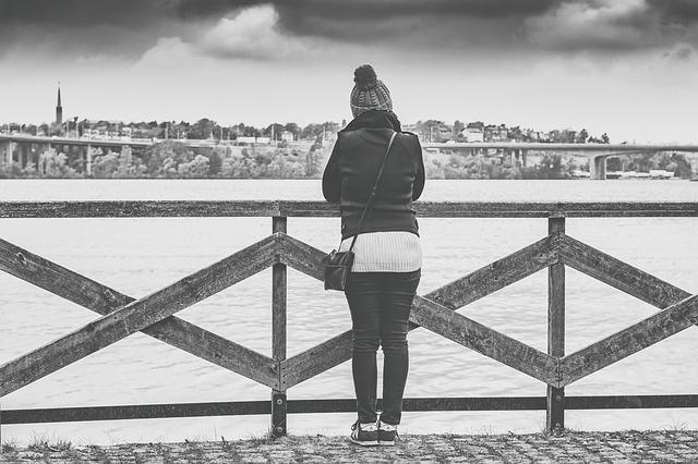 Depression - woman thinking, grey skies. CREDIT: qimono / Pixabay (CC0)