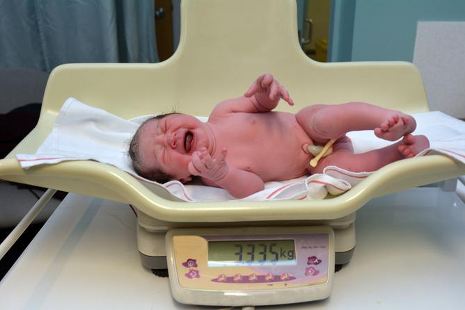 Newborn being weighed
