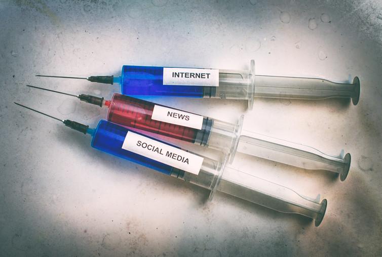 Syringes labelled Internet, news, social media.