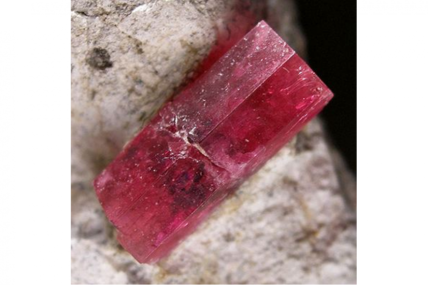 An uncut piece of red gemstone