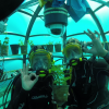 Two scuba divers inside one of the greenhouses