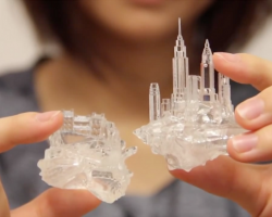 3D printed, transparent shells for hermit crabs, tiny cityscapes rise off the backs of each one.