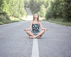 Woman meditating on a road