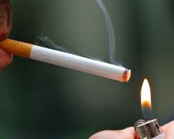 Smoker lighting up a cigarette.