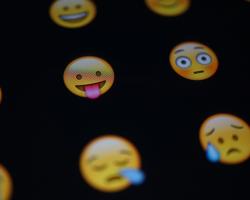 Texting emojis on a smartphone screen.