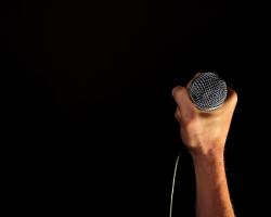 hand clutching a microphone.