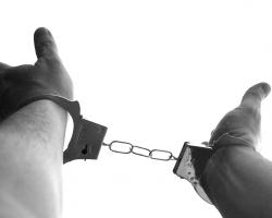 Hands in handcuffs, black and white photo