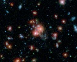 This image, using data from Spitzer and the Hubble Space Telescope, shows the galaxy cluster SpARCS1049.