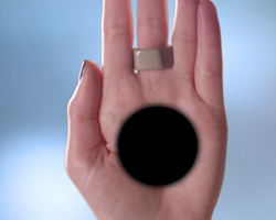 Optical illusion of a black hole in the middle of a hand