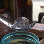 Spoon holding gelatinous water for deep frying