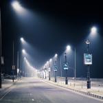 Streetlights illuminate an empty road at night